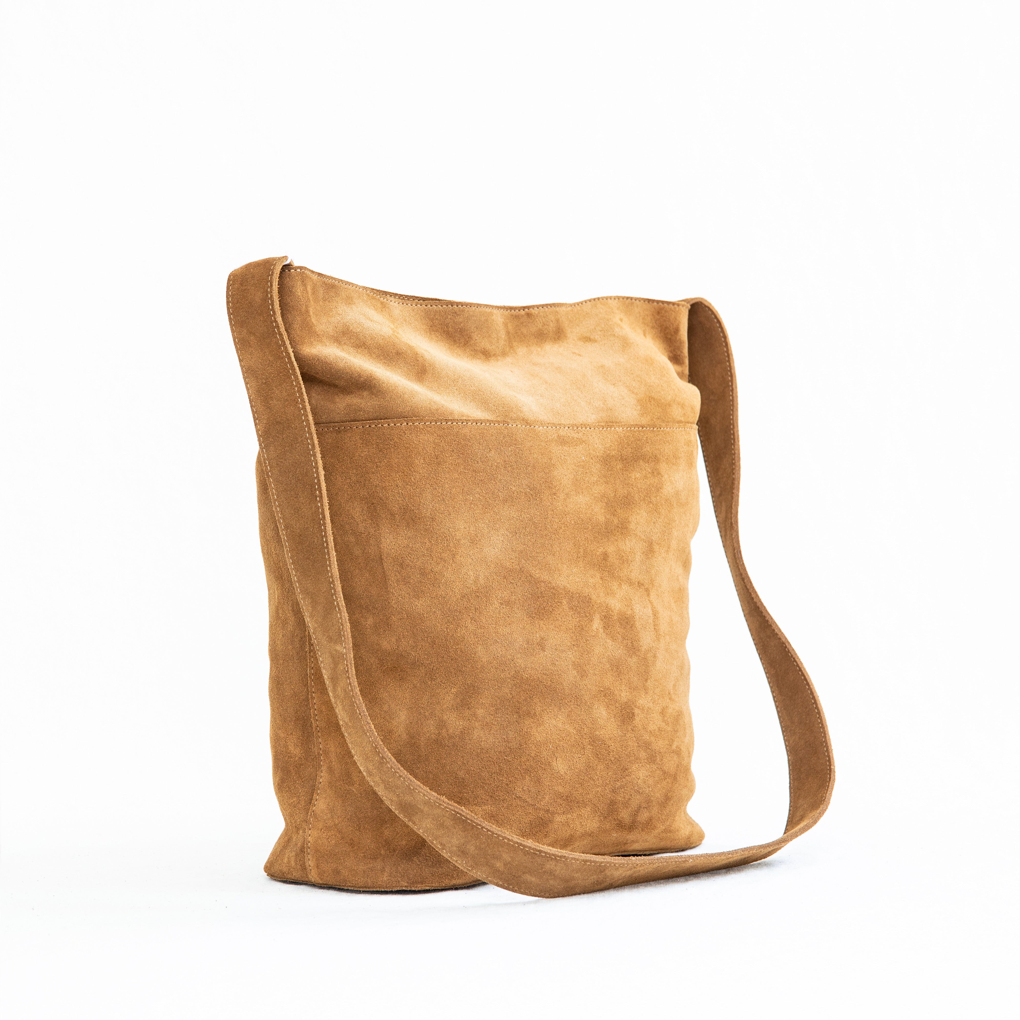 A brown suede crossbody bag with a shoulder strap, displayed against a white background.