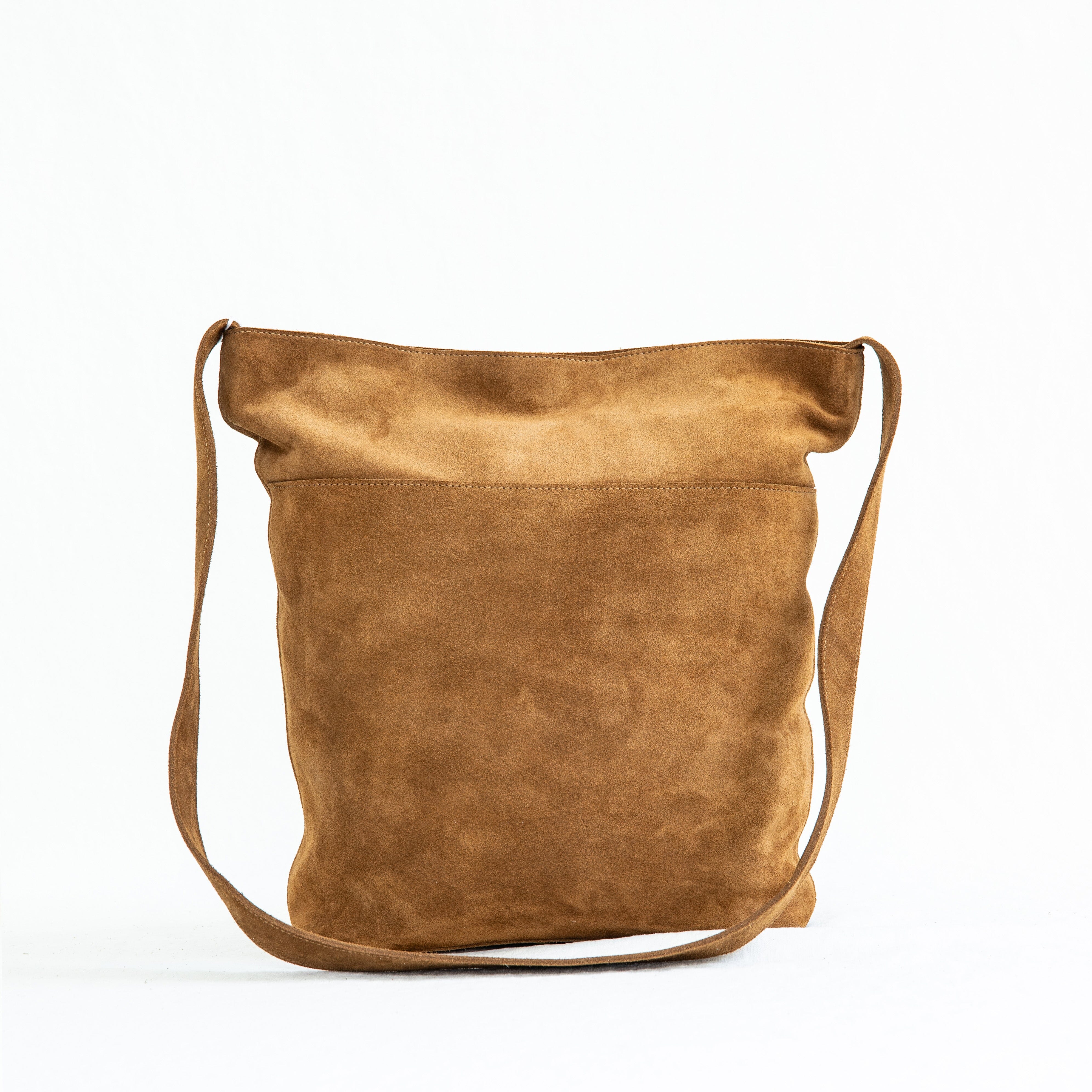 A brown suede crossbody bag with a shoulder strap, displayed against a white background.